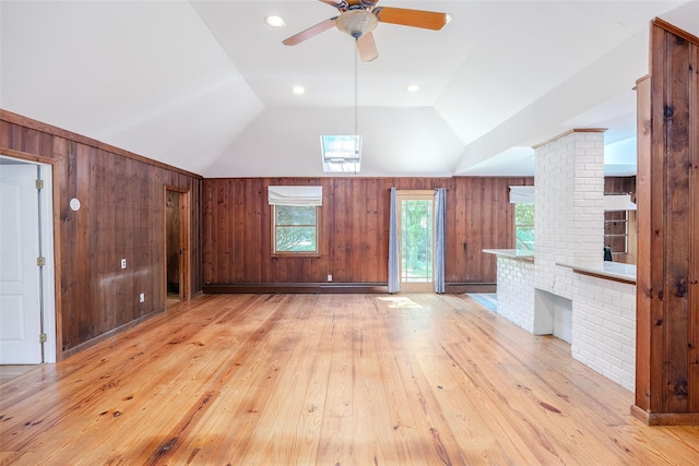 82A Union Ave, Center Moriches, NY 11934 - unfurnished living room with wood walls, light wood finished floors, a ceiling fan, and vaulted ceiling