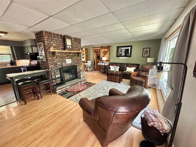 282 Petticoat Ln, Bloomingburg, NY 12721 - living area with a drop ceiling, light wood-style flooring, and a fireplace