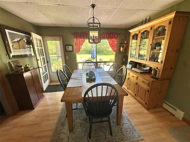282 Petticoat Ln, Bloomingburg, NY 12721 - dining area featuring baseboard heating, a drop ceiling, and light wood-type flooring