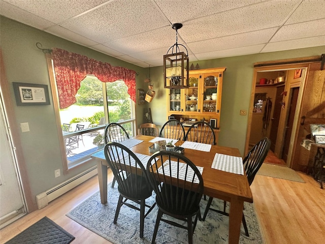 282 Petticoat Ln, Bloomingburg, NY 12721 - dining area featuring baseboard heating, a drop ceiling, and light wood finished floors