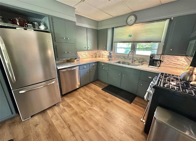 282 Petticoat Ln, Bloomingburg, NY 12721 - kitchen with appliances with stainless steel finishes, a drop ceiling, backsplash, light wood finished floors, and light countertops