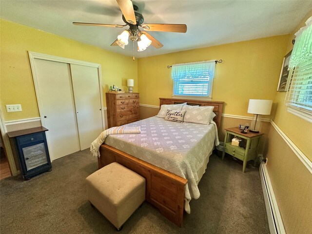 282 Petticoat Ln, Bloomingburg, NY 12721 - carpeted bedroom featuring a baseboard heating unit, multiple windows, a closet, and ceiling fan