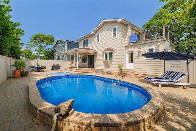 135 Flamingo St, Atlantic Beach, NY 11509 - view of swimming pool featuring entry steps, a fenced backyard, a patio, and area for grilling