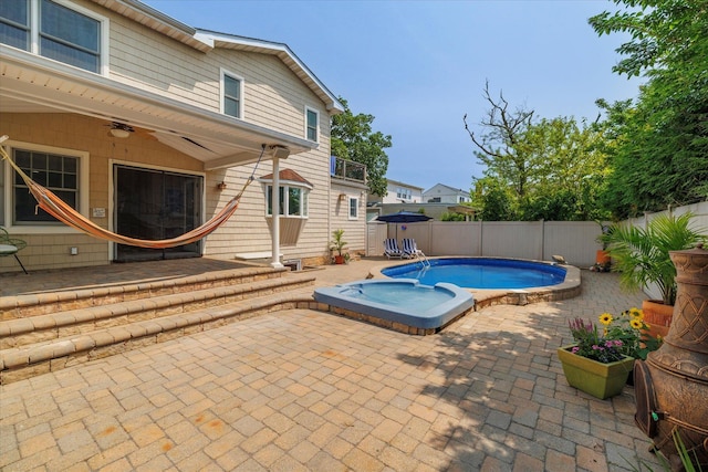 135 Flamingo St, Atlantic Beach, NY 11509 - view of pool featuring a patio area, a fenced backyard, ceiling fan, and a hot tub