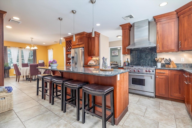 135 Flamingo St, Atlantic Beach, NY 11509 - kitchen featuring appliances with stainless steel finishes, wall chimney exhaust hood, a center island, dark stone counters, and recessed lighting