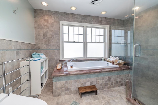 135 Flamingo St, Atlantic Beach, NY 11509 - full bath featuring tile patterned flooring, a bath, a shower stall, tile walls, and recessed lighting