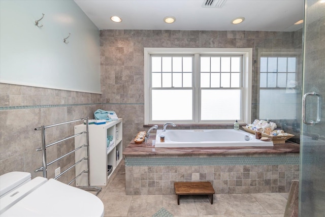 135 Flamingo St, Atlantic Beach, NY 11509 - full bathroom with tile walls, tile patterned flooring, a bath, a stall shower, and recessed lighting