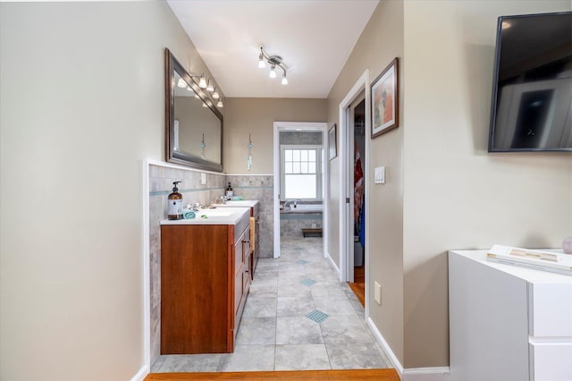 135 Flamingo St, Atlantic Beach, NY 11509 - full bathroom with vanity, tile patterned flooring, and tile walls