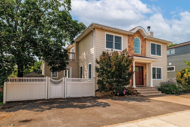 135 Flamingo St, Atlantic Beach, NY 11509 - view of front facade featuring a gate, a chimney, and stone siding