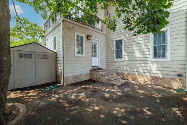 135 Flamingo St, Atlantic Beach, NY 11509 - rear view of house featuring a storage unit and entry steps