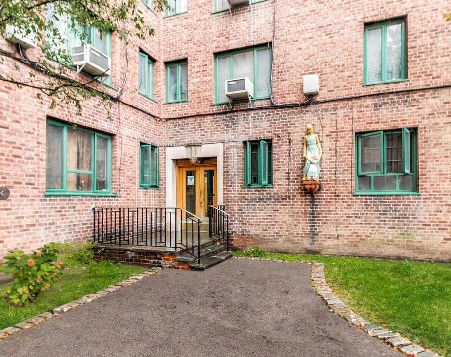 2059 Mcgraw Ave Unit 6A, Bronx, NY 10462 - view of exterior entry featuring french doors, brick siding, and cooling unit