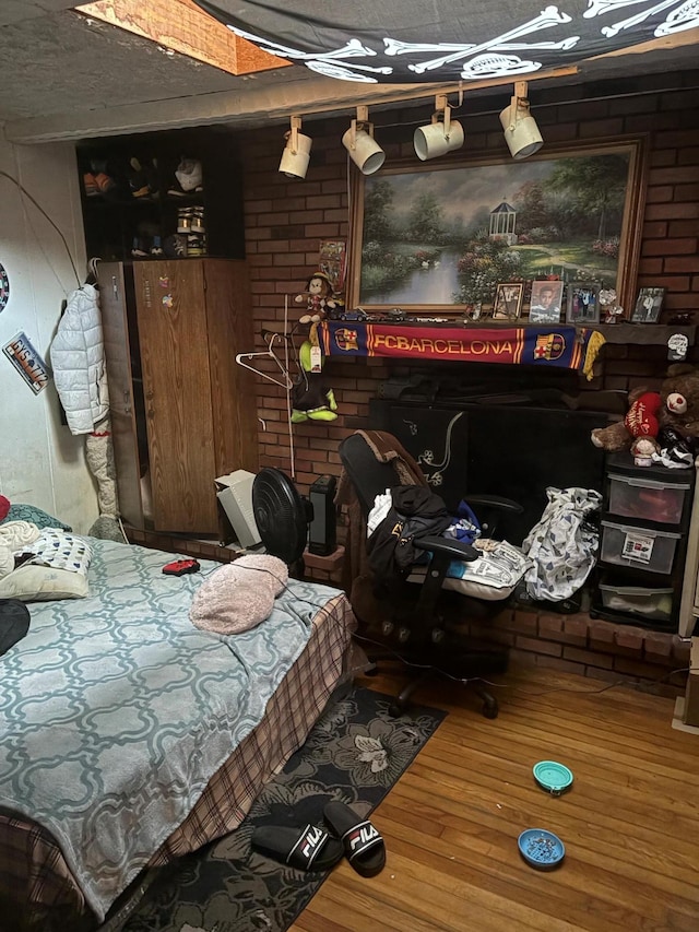 40 Samuel St, Ronkonkoma, NY 11779 - bedroom with wood finished floors and brick wall