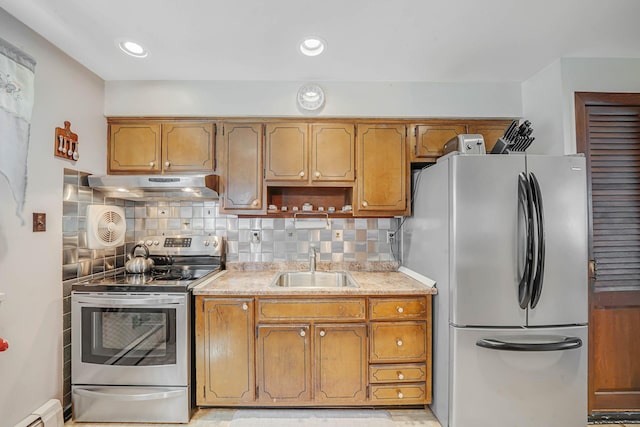47 Tucker Dr, Bayport, NY 11705 - kitchen with stainless steel appliances, under cabinet range hood, light countertops, tasteful backsplash, and brown cabinetry