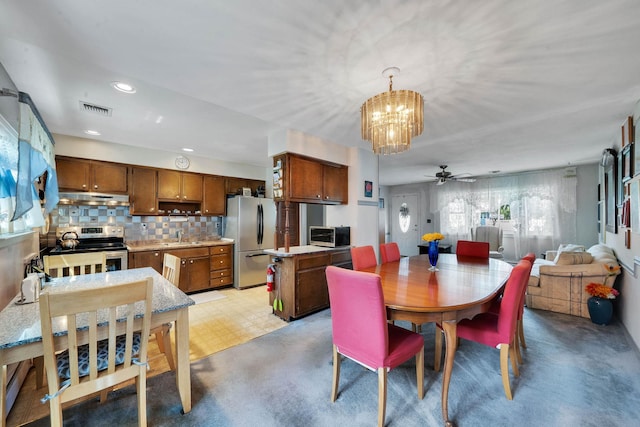 47 Tucker Dr, Bayport, NY 11705 - dining area with a ceiling fan, a chandelier, and recessed lighting