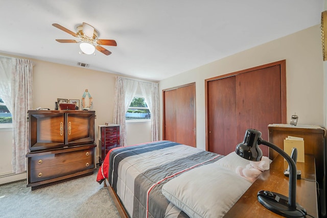47 Tucker Dr, Bayport, NY 11705 - carpeted bedroom with multiple closets and a ceiling fan