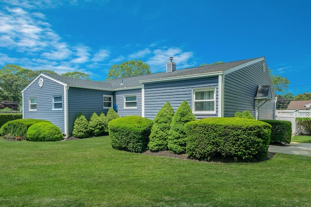 47 Tucker Dr, Bayport, NY 11705 - view of side of home with a chimney and a shingled roof