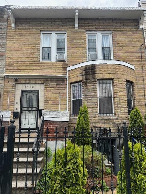 2718 Holland Ave, Bronx, NY 10467 - view of property featuring a fenced front yard and stone siding