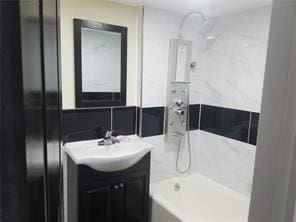 2718 Holland Ave, Bronx, NY 10467 - full bathroom with vanity and  shower combination