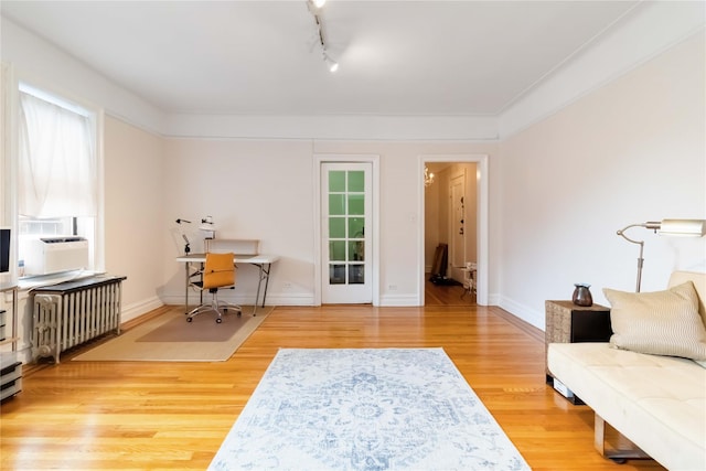83-10 35th Ave Unit 5B, Jackson Heights, NY 11372 - home office featuring wood finished floors, radiator heating unit, cooling unit, and track lighting