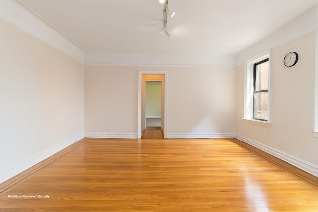 83-10 35th Ave Unit 5B, Jackson Heights, NY 11372 - empty room with light wood-style flooring and rail lighting
