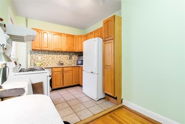 83-10 35th Ave Unit 5B, Jackson Heights, NY 11372 - kitchen with white appliances, decorative backsplash, light countertops, and extractor fan