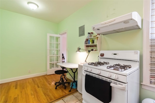 83-10 35th Ave Unit 5B, Jackson Heights, NY 11372 - kitchen with white gas stove, under cabinet range hood, and light wood-type flooring