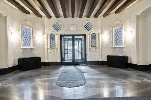 83-10 35th Ave Unit 5B, Jackson Heights, NY 11372 - building lobby featuring a textured wall and beamed ceiling
