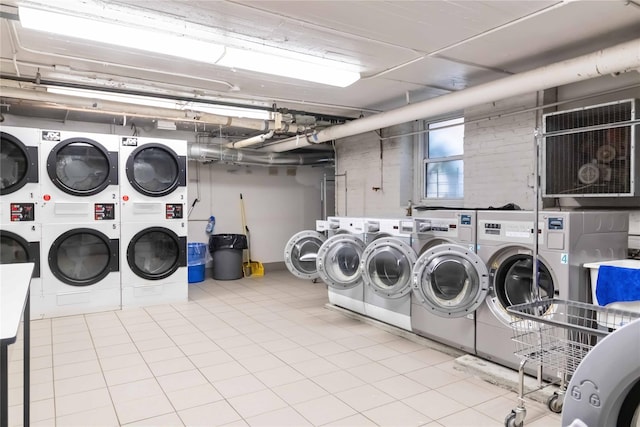 83-10 35th Ave Unit 5B, Jackson Heights, NY 11372 - community laundry with stacked washer / dryer, washer and clothes dryer, and tile patterned flooring