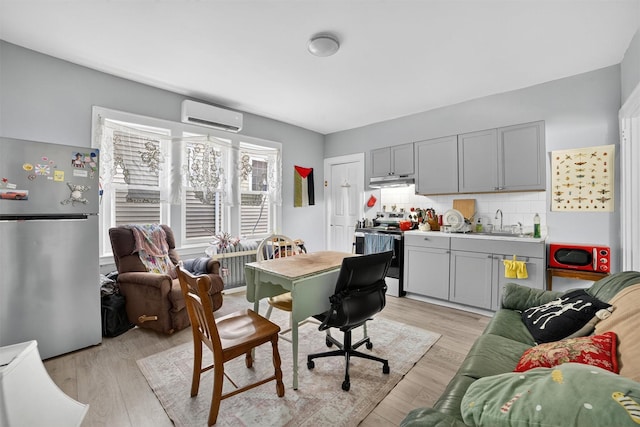 439 S 7th Ave, Mount Vernon, NY 10550 - home office with a wall mounted air conditioner and light wood-type flooring