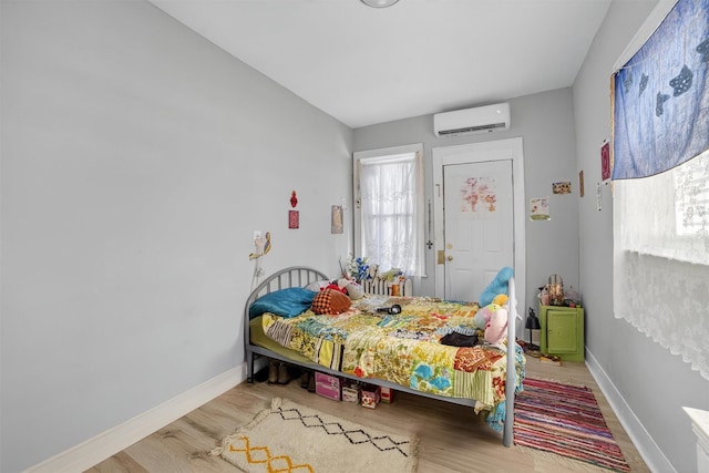 439 S 7th Ave, Mount Vernon, NY 10550 - bedroom featuring an AC wall unit, wood finished floors, and multiple windows