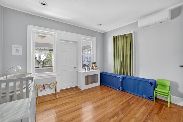 439 S 7th Ave, Mount Vernon, NY 10550 - unfurnished bedroom with an AC wall unit, light wood-style floors, and crown molding