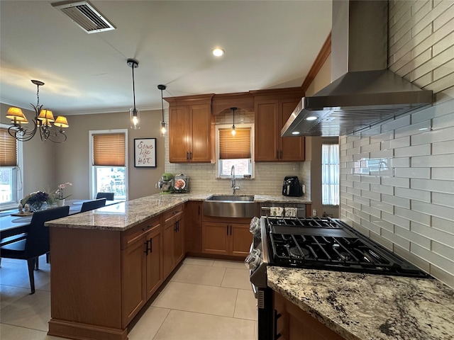 226 James St, Franklin Square, NY 11010 - kitchen with range with gas cooktop, wall chimney exhaust hood, tasteful backsplash, a chandelier, and ornamental molding