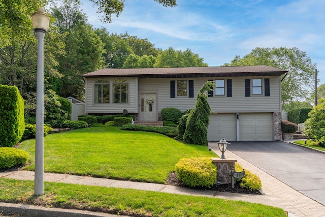 11 Val Ct, Commack, NY 11725 - raised ranch with an attached garage, asphalt driveway, and a front lawn