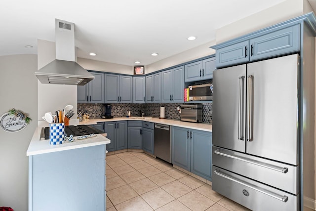 11 Val Ct, Commack, NY 11725 - kitchen with appliances with stainless steel finishes, island range hood, light tile patterned floors, decorative backsplash, and light countertops