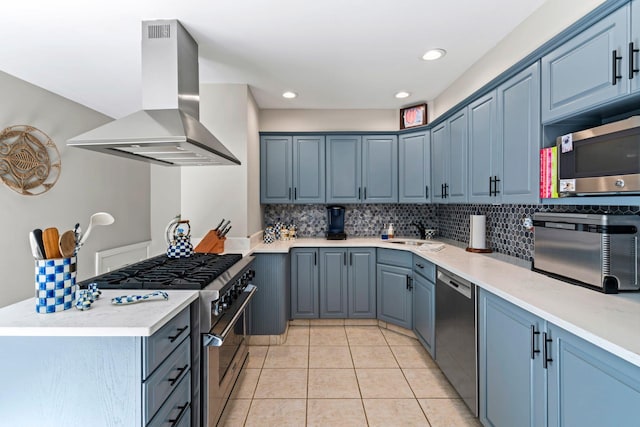 11 Val Ct, Commack, NY 11725 - kitchen with island range hood, stainless steel appliances, backsplash, light countertops, and recessed lighting