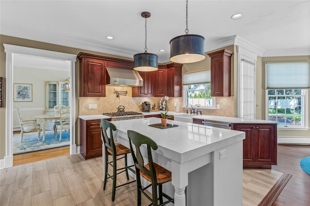 17 Pheasant Run Ln, Dix Hills, NY 11746 - kitchen with wall chimney range hood, dark brown cabinets, light countertops, pendant lighting, and ornamental molding