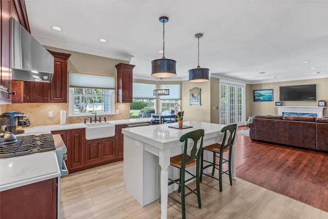 17 Pheasant Run Ln, Dix Hills, NY 11746 - kitchen featuring wall chimney exhaust hood, light countertops, backsplash, ornamental molding, and open floor plan