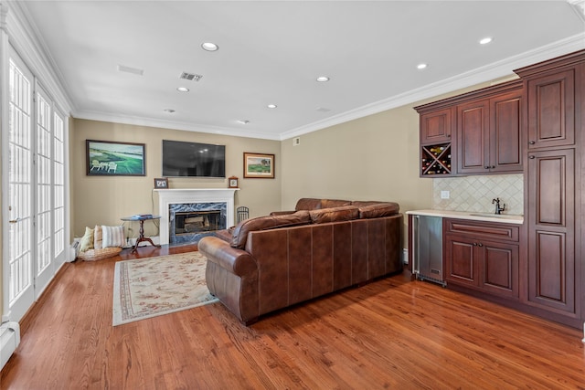 17 Pheasant Run Ln, Dix Hills, NY 11746 - living area with wood finished floors, a fireplace, recessed lighting, ornamental molding, and baseboard heating