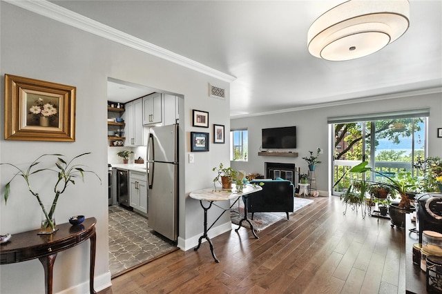 29D Windle Park Unit D, Tarrytown, NY 10591 - living room featuring ornamental molding, dark wood-type flooring, healthy amount of natural light, and a glass covered fireplace
