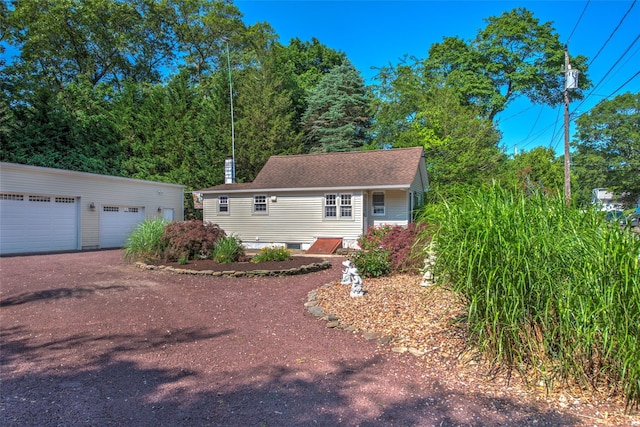 62 Port Washington Rd, Sound Beach, NY 11789 - view of front facade with an outbuilding, a chimney, a garage, and roof with shingles