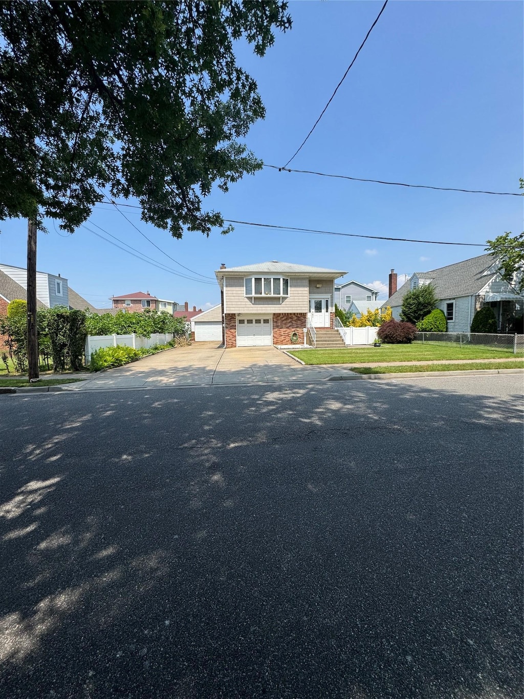 14 Edwards Pl, Valley Stream, NY 11580 - raised ranch with an attached garage and asphalt driveway