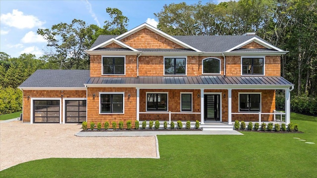 128 Sandy Hollow Rd, Southampton, NY 11968 - view of front facade with a standing seam roof, covered porch, a garage, driveway, and a front yard