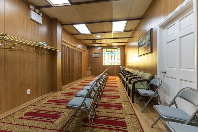 5836 Catalpa Ave, Ridgewood, NY 11385 - cinema with wood walls, wood finished floors, and a wall mounted air conditioner