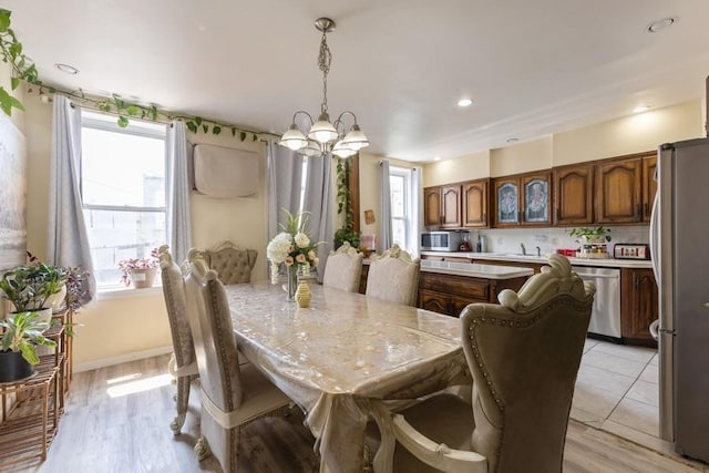 5836 Catalpa Ave, Ridgewood, NY 11385 - dining room with a chandelier, light wood-style flooring, and recessed lighting