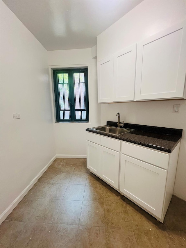 1722 Purdy St Unit 1H, Bronx, NY 10462 - kitchen featuring dark countertops, white cabinets, and light tile patterned floors