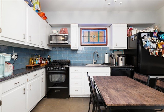 209 Venetian Blvd, Lindenhurst, NY 11757 - kitchen featuring black appliances, dark countertops, white cabinetry, and tasteful backsplash