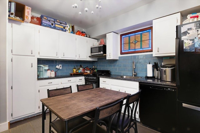 209 Venetian Blvd, Lindenhurst, NY 11757 - kitchen featuring black appliances, backsplash, dark countertops, and white cabinets