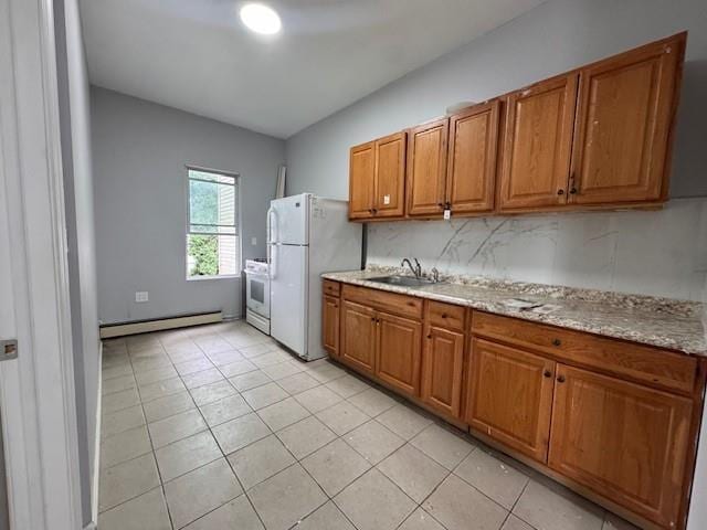 10326 171st St, Jamaica, NY 11433 - kitchen with baseboard heating, white appliances, brown cabinetry, light tile patterned floors, and light stone counters