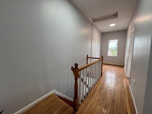 10326 171st St, Jamaica, NY 11433 - corridor featuring an upstairs landing, attic access, hardwood / wood-style floors, and a baseboard radiator