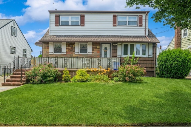 66 Gates Ave, Valley Stream, NY 11580 - view of front of home with roof with shingles, a front yard, covered porch, and stone siding